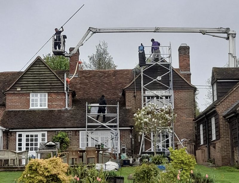 The Roof Moss Cleaners using cherry picker and scaffolding to clean roof safely and professionally in Ewell, Surrey
