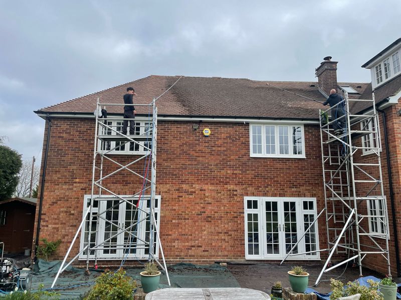 Roof cleaning carried out safely from scaffold towers by The Roof Moss Cleaners in Ewell